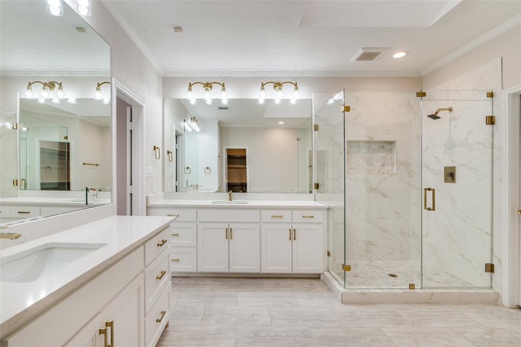 6027 High Court Place Dallas, TX 75254 - Photo 18 of 26 a spacious bathroom with a shower a sink and a mirror