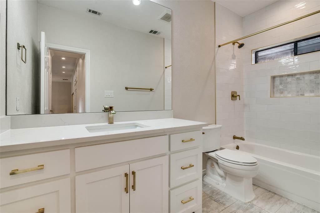 6027 High Court Place Dallas, TX 75254 - Photo 21 of 26 a bathroom with a sink a toilet and a large mirror