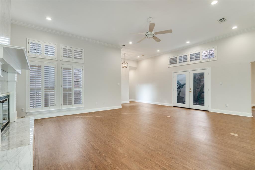 6027 High Court Place Dallas, TX 75254 - Photo 6 of 26 an empty room with wooden floor and windows
