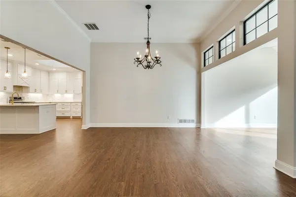 a view of a livingroom with wooden floor and a ceiling fan