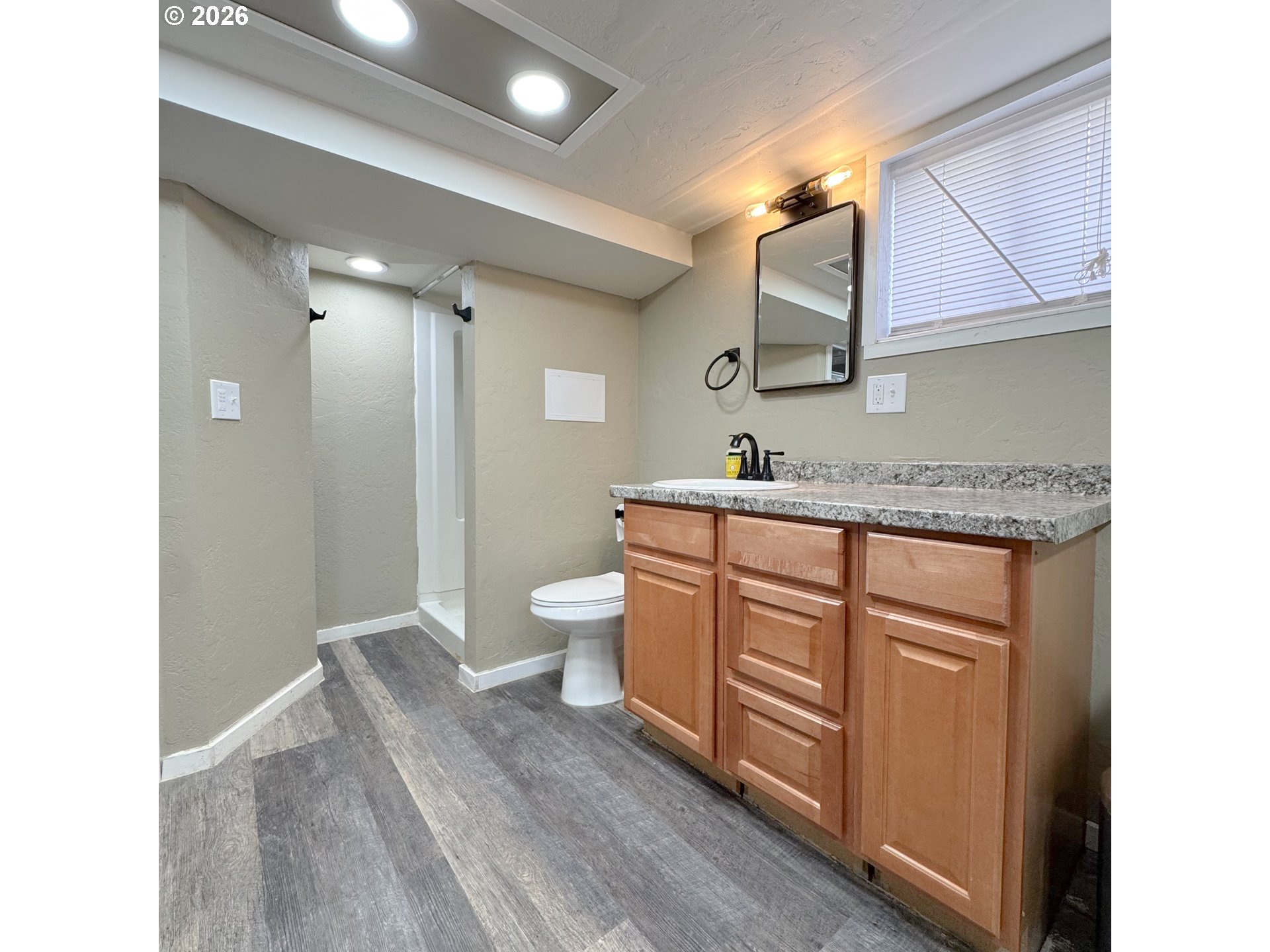 2414 3rd Street Baker City, OR 97814 - Photo 16 of 23 a bathroom with a granite countertop sink mirror and a toilet