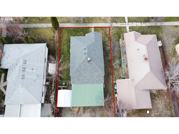 an aerial view of a house with a yard and balcony
