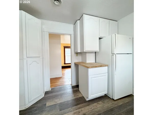 a kitchen with white cabinets and white appliances