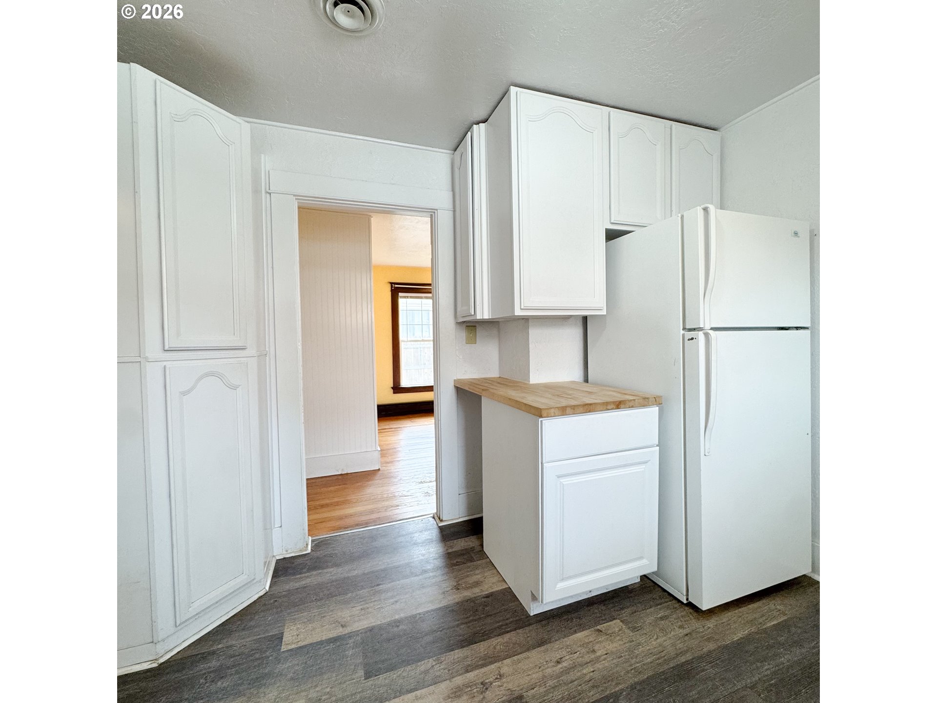 2414 3rd Street Baker City, OR 97814 - Photo 7 of 23 a kitchen with white cabinets and white appliances