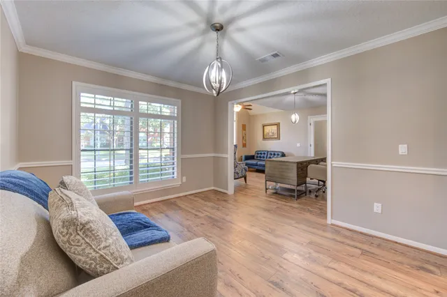 a living room with furniture a flat screen tv and a large window