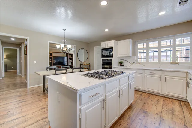 an open kitchen with a sink and dish washer