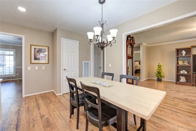 a kitchen with stainless steel appliances kitchen island granite countertop a stove a sink dishwasher and a refrigerator with wooden floor