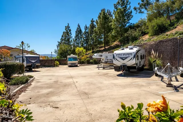a view of a street with cars parked