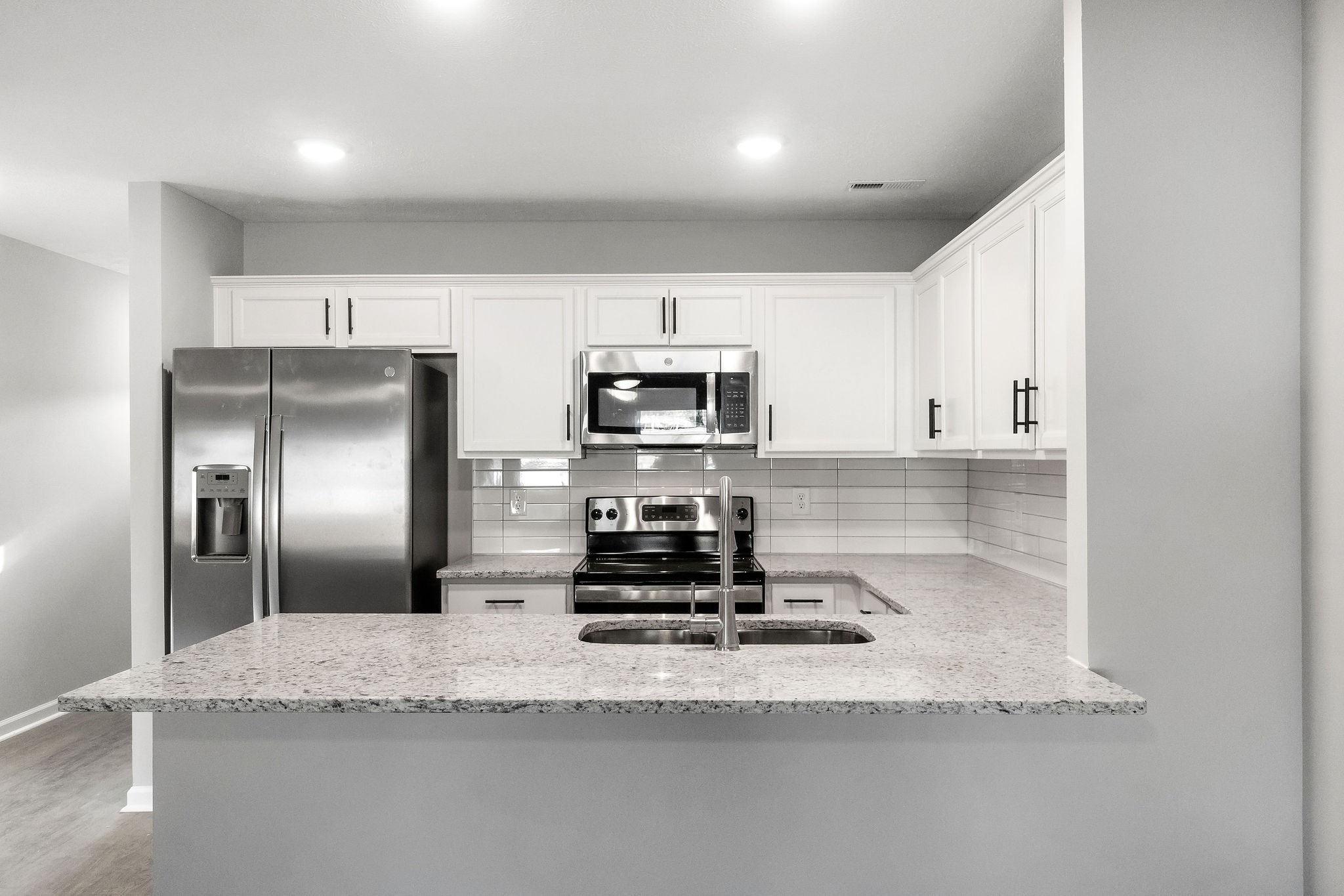 301 Longshadow Trail, Unit B Clarksville, TN 37043 - Photo 6 of 29 a kitchen with granite countertop a refrigerator and a sink