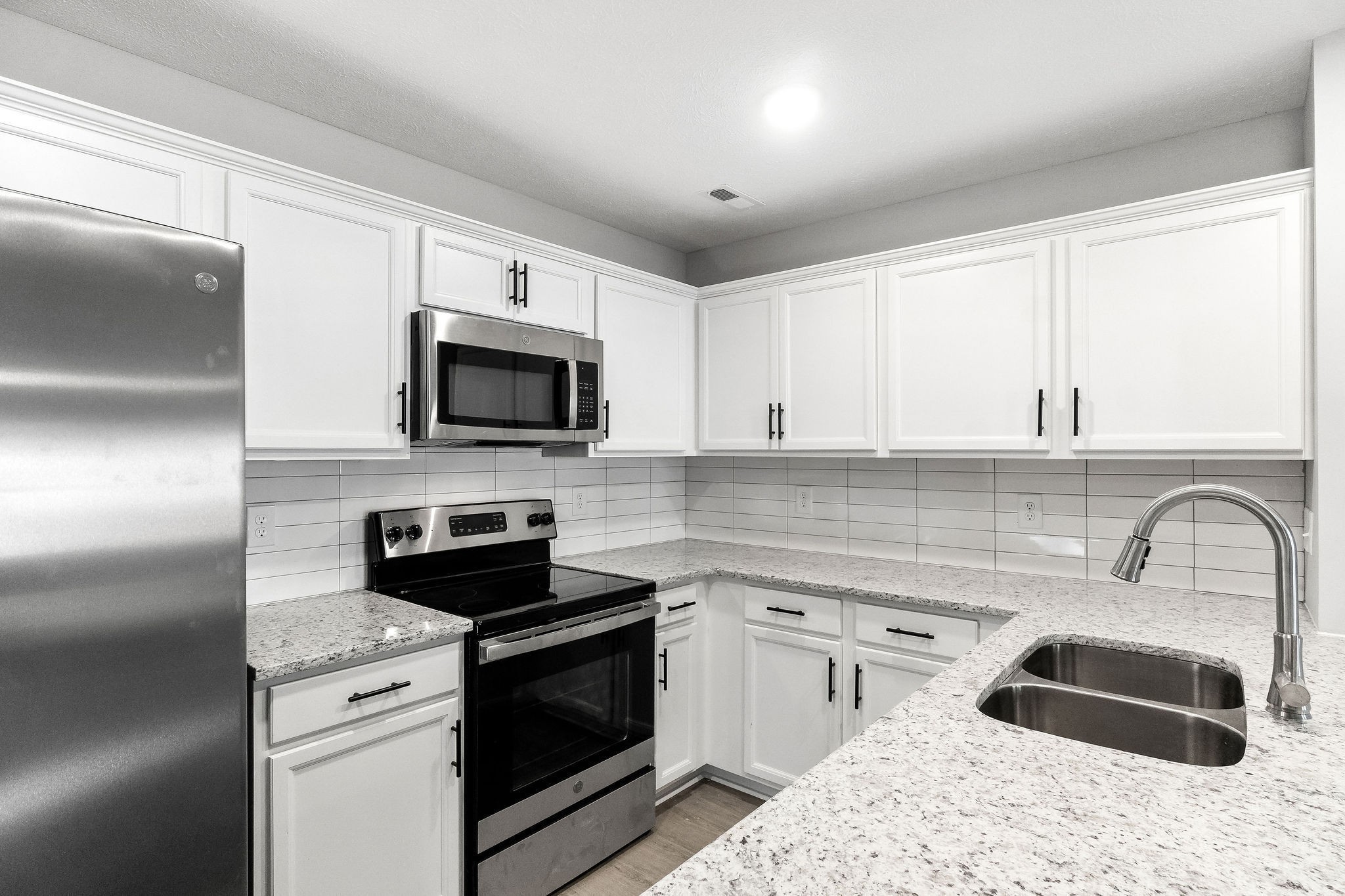 301 Longshadow Trail, Unit B Clarksville, TN 37043 - Photo 7 of 29 a kitchen with a sink stove and microwave