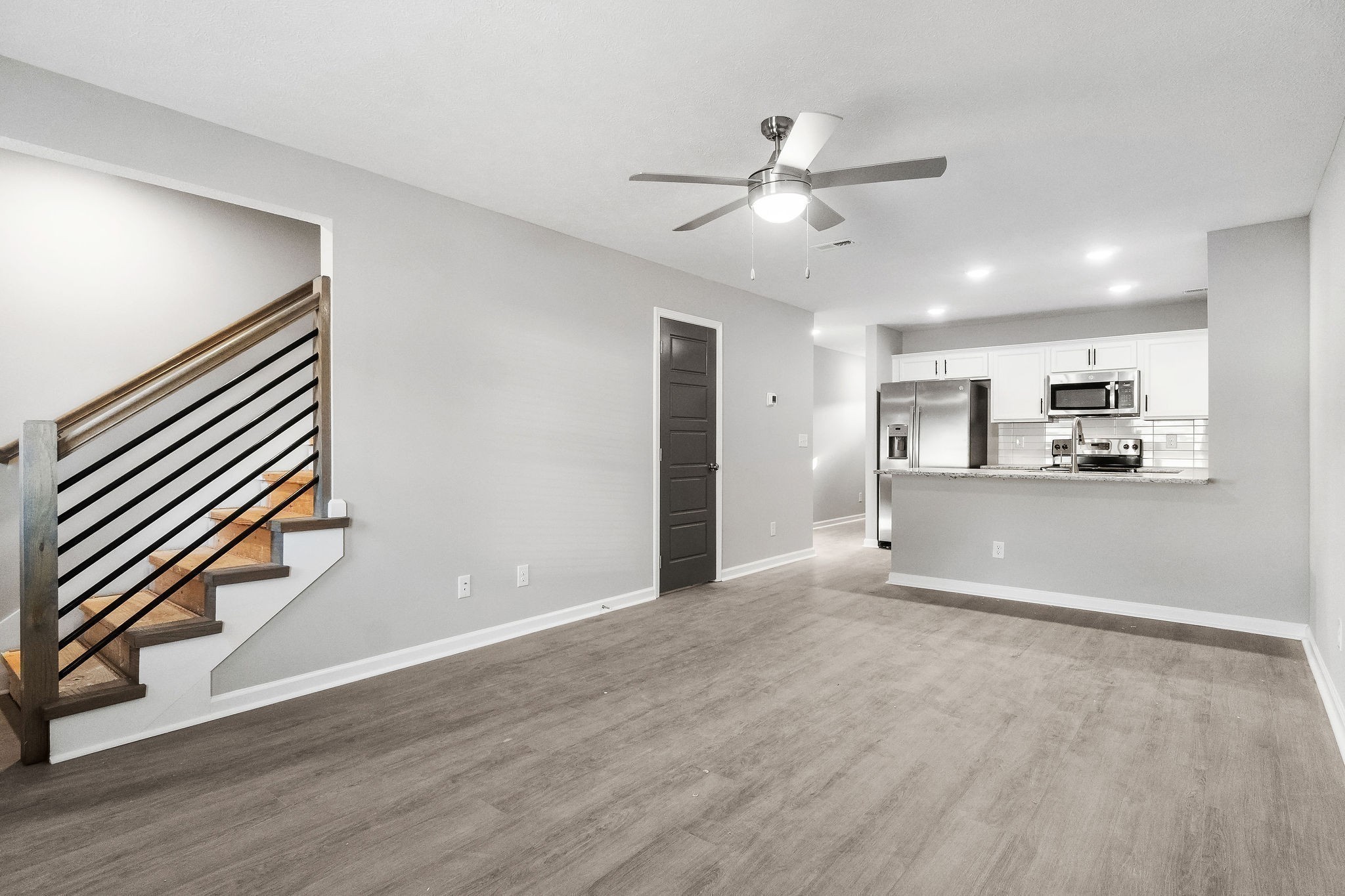 301 Longshadow Trail, Unit B Clarksville, TN 37043 - Photo 10 of 29 a view of kitchen and empty room with wooden floor