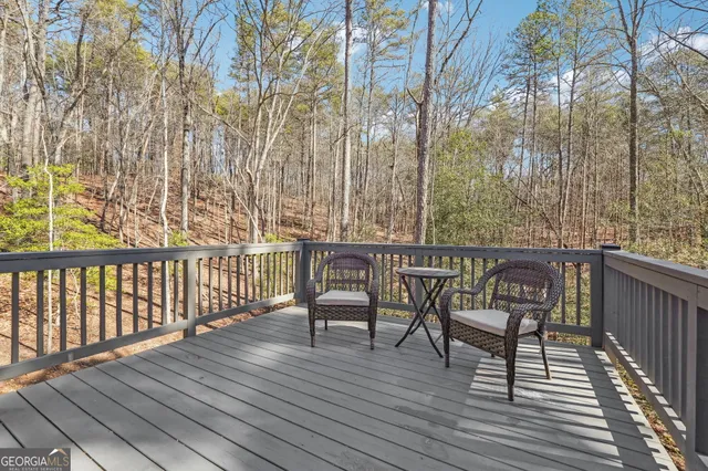 a view of a deck with wooden floor and furniture