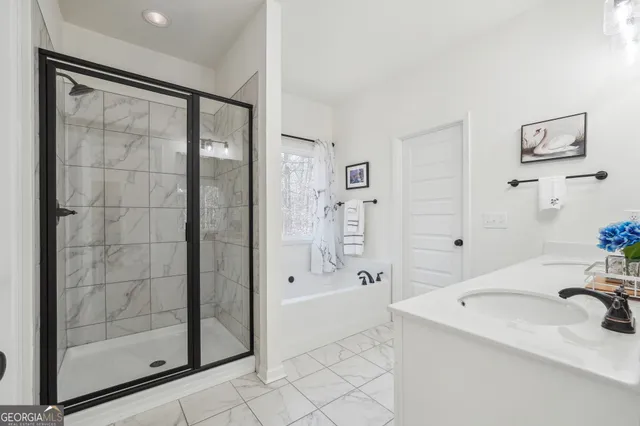 a bathroom with a double vanity sink a mirror and a shower