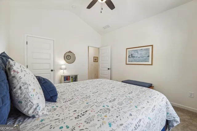 a bathroom with a granite countertop sink a toilet and a mirror