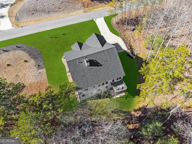 an aerial view of a house with a yard