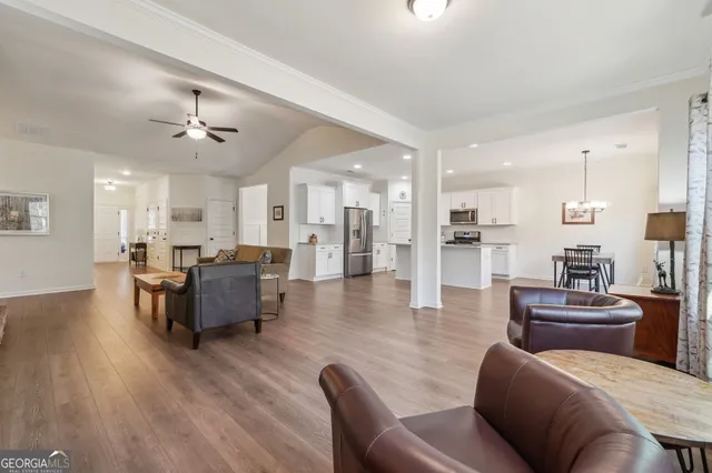 a kitchen with stainless steel appliances a refrigerator a stove top oven a sink and cabinets