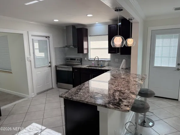 a kitchen with a sink cabinets and wooden floor
