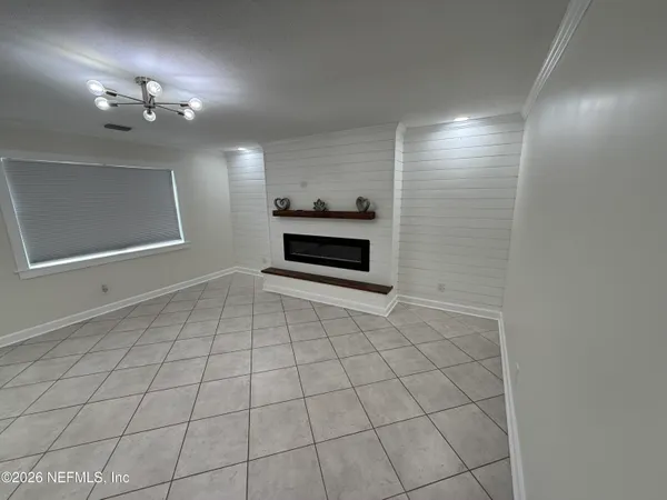 a view of an empty room with a mirror