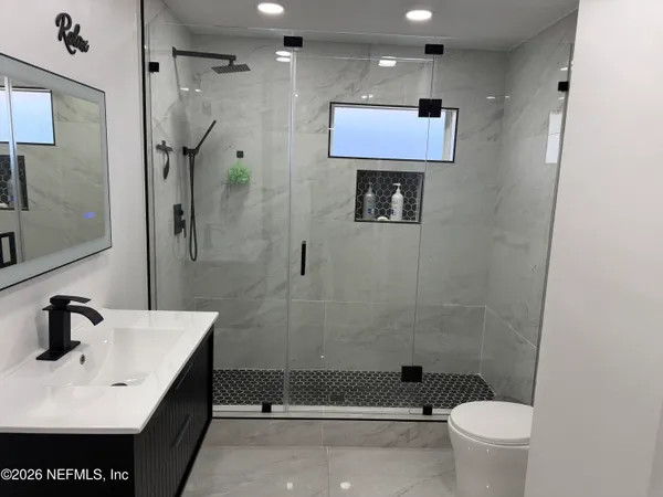 a bathroom with a sink toilet and shower