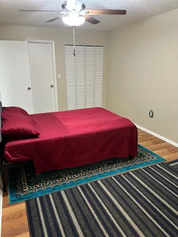a bed sitting in a bedroom next to a window