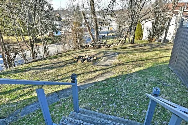 a view of a yard with wooden fence