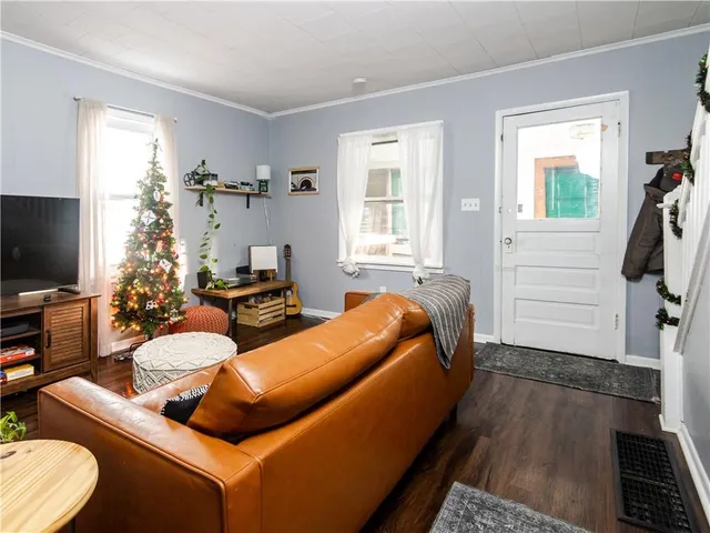 a bedroom with furniture and a flat screen tv