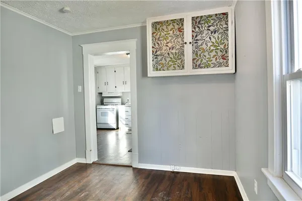 a view of a kitchen with wooden floor and a kitchen