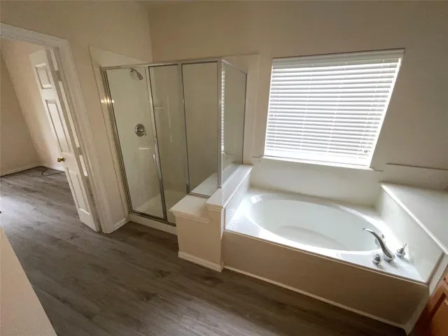 a bathroom with a bathtub and a shower