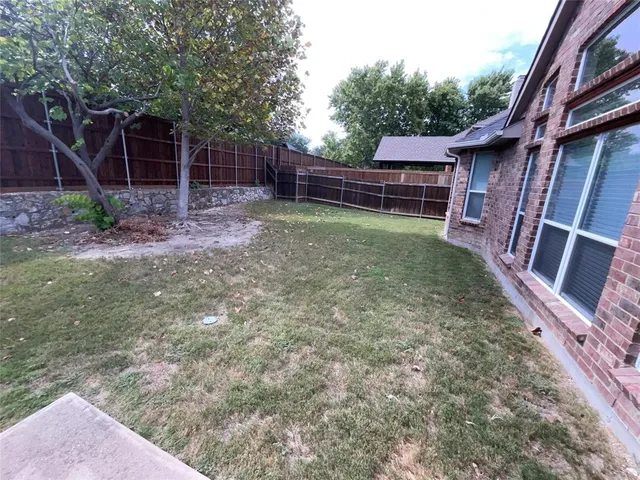 a backyard of a house with lots of green space