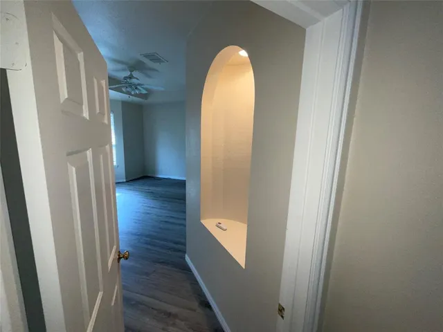 a view of a room with wooden floor