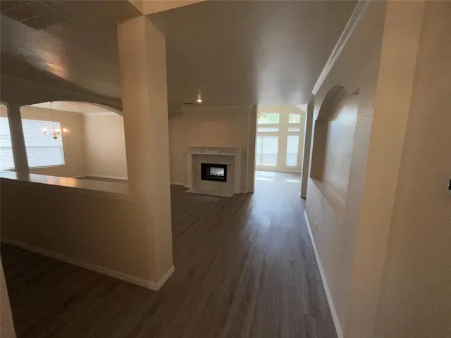 wooden floor in a hall with a window