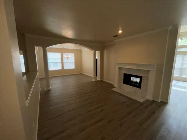 a view of a livingroom with wooden floor and a fireplace