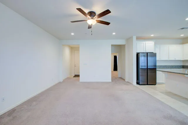 a view of an empty room with a ceiling fan