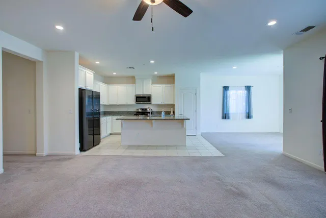 a view of kitchen with refrigerator and microwave
