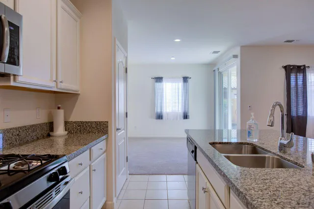 a kitchen with granite countertop a sink and a stove