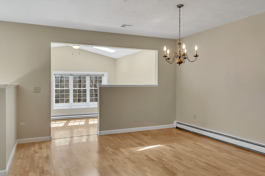 307 Ridgefield Circle, Unit A Clinton, MA 01510 - Photo 11 of 42 a view of empty room with wooden floor and fan
