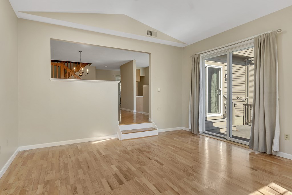 307 Ridgefield Circle, Unit A Clinton, MA 01510 - Photo 12 of 42 a view of an empty room with wooden floor and a window