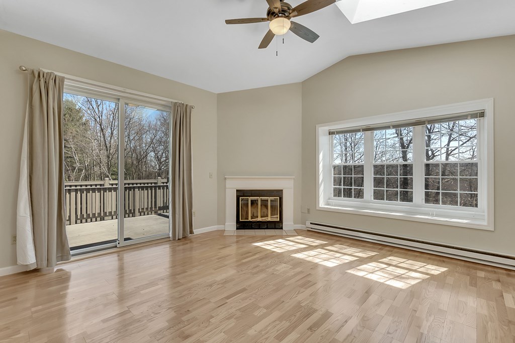307 Ridgefield Circle, Unit A Clinton, MA 01510 - Photo 13 of 42 a view of an empty room with a window and wooden floor