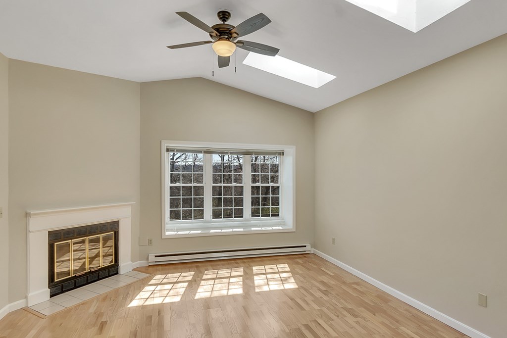 307 Ridgefield Circle, Unit A Clinton, MA 01510 - Photo 14 of 42 a view of an empty room with a window and wooden floor