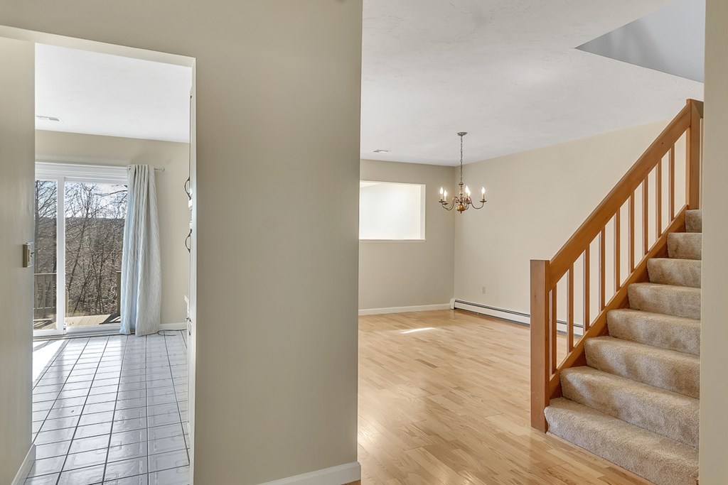 307 Ridgefield Circle, Unit A Clinton, MA 01510 - Photo 19 of 42 a view of an entryway with wooden floor and stairs