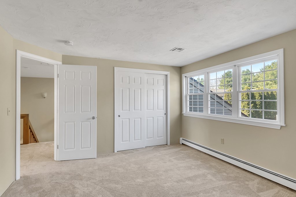 307 Ridgefield Circle, Unit A Clinton, MA 01510 - Photo 25 of 42 an empty room with windows and closet