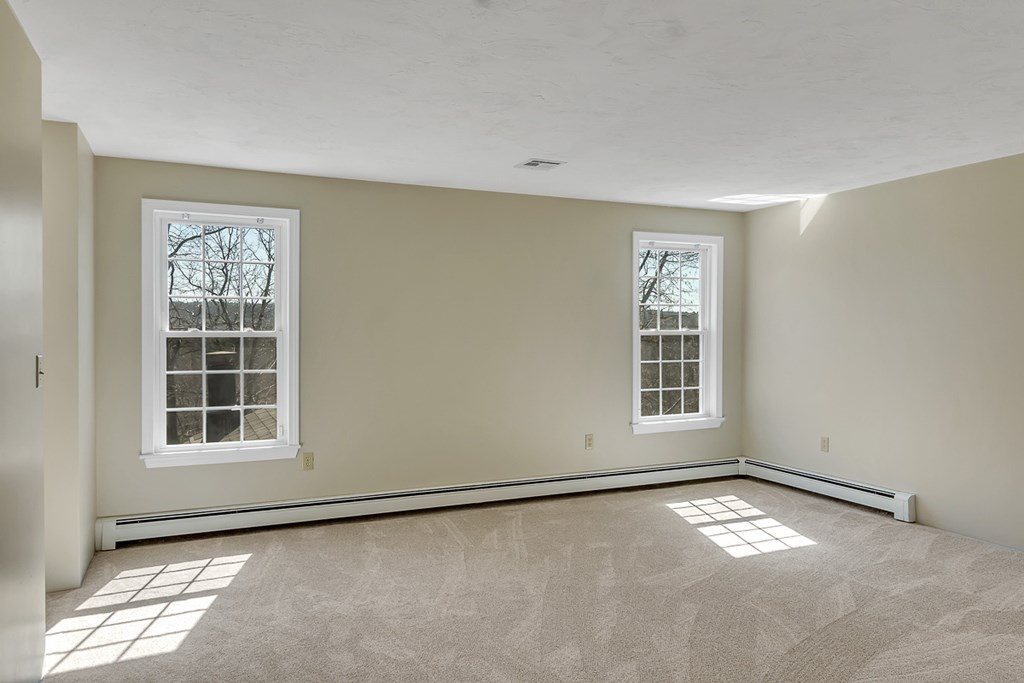 307 Ridgefield Circle, Unit A Clinton, MA 01510 - Photo 26 of 42 an empty room with a empty space and windows