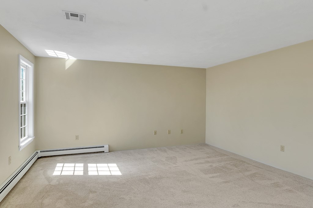 307 Ridgefield Circle, Unit A Clinton, MA 01510 - Photo 28 of 42 an empty room with a empty space and windows