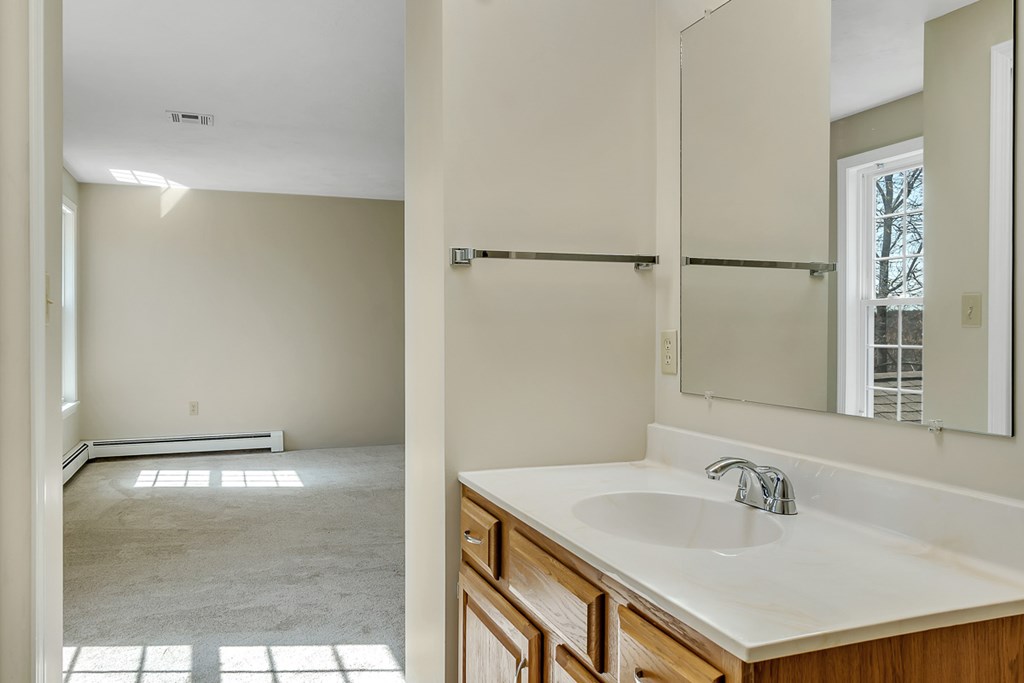 307 Ridgefield Circle, Unit A Clinton, MA 01510 - Photo 30 of 42 a bathroom with a sink and a mirror