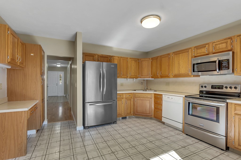 307 Ridgefield Circle, Unit A Clinton, MA 01510 - Photo 3 of 42 a kitchen with a refrigerator sink and cabinets