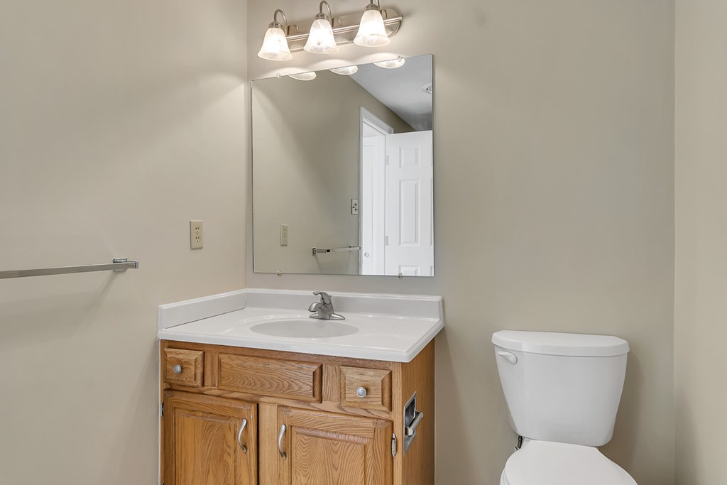 307 Ridgefield Circle, Unit A Clinton, MA 01510 - Photo 31 of 42 a bathroom with a toilet sink and mirror