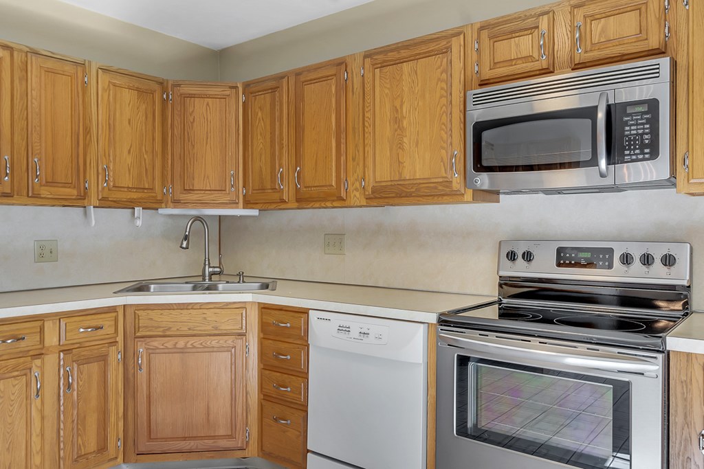 307 Ridgefield Circle, Unit A Clinton, MA 01510 - Photo 4 of 42 a kitchen with granite countertop cabinets stainless steel appliances and wooden cabinets