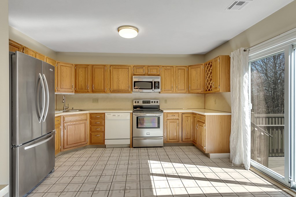 307 Ridgefield Circle, Unit A Clinton, MA 01510 - Photo 5 of 42 a kitchen with a refrigerator sink and cabinets