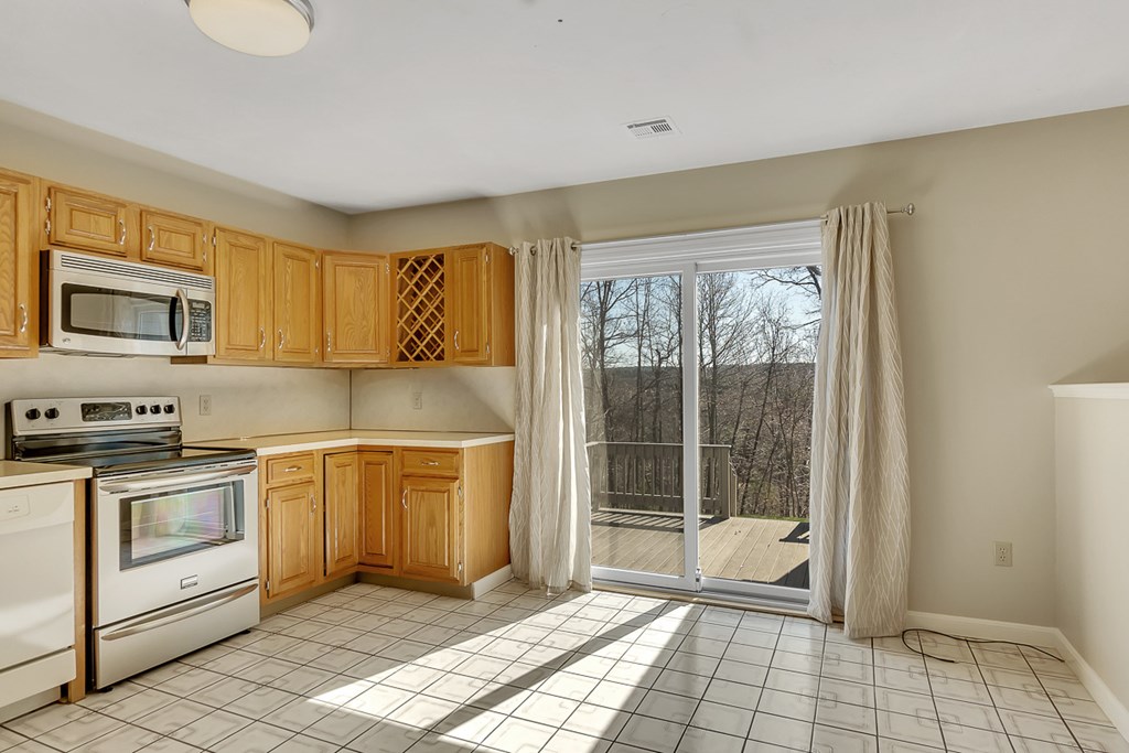 307 Ridgefield Circle, Unit A Clinton, MA 01510 - Photo 6 of 42 a kitchen with a stove a sink and a granite counter top