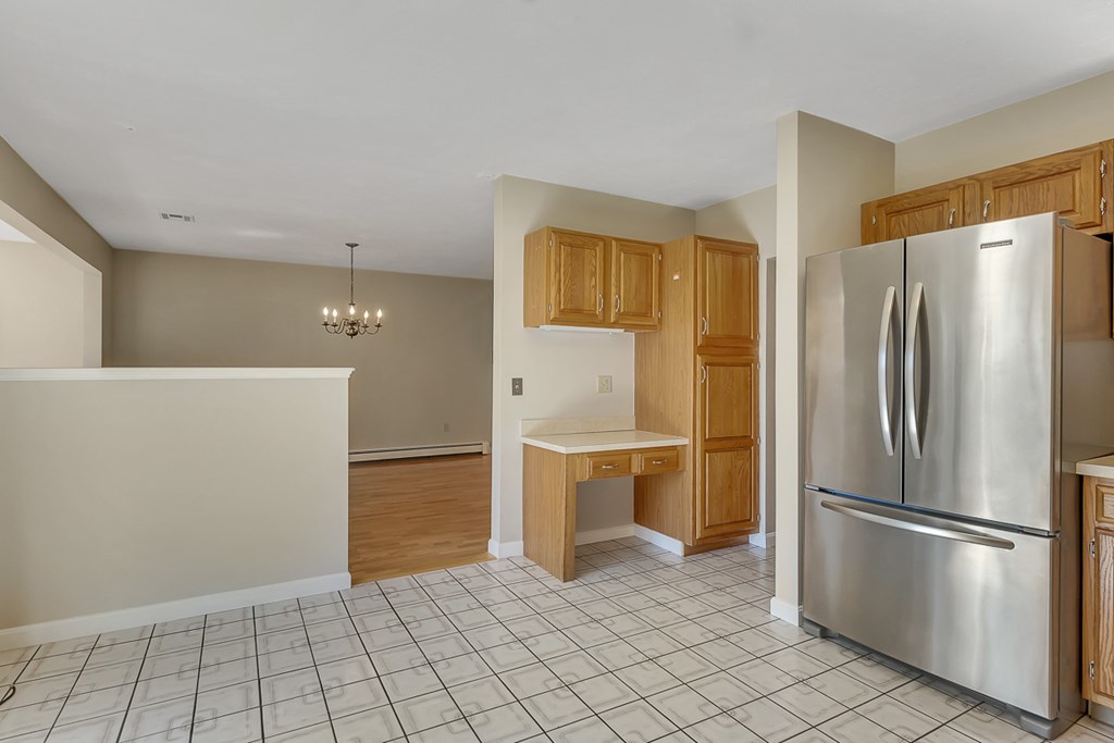307 Ridgefield Circle, Unit A Clinton, MA 01510 - Photo 7 of 42 a kitchen with stainless steel appliances a refrigerator and a stove top oven